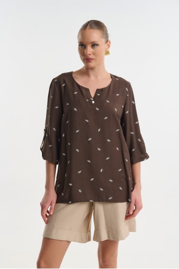 Blouse with decorative button
